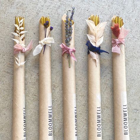 four different types of flowers wrapped in brown paper